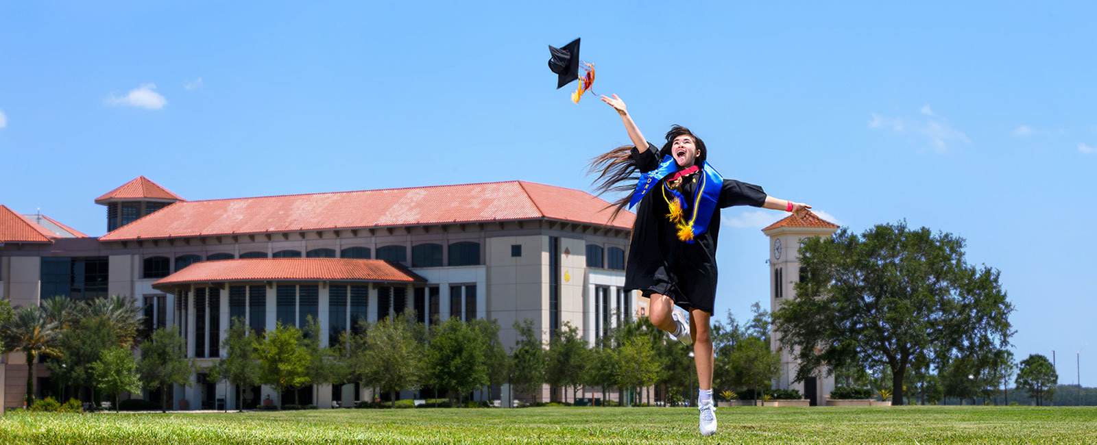 Erika Nielsen throwing grad cap with joy