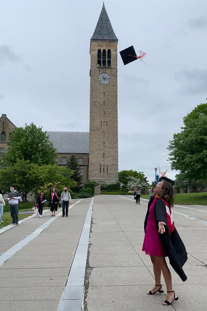 Melodie Cros throwing graduation cap