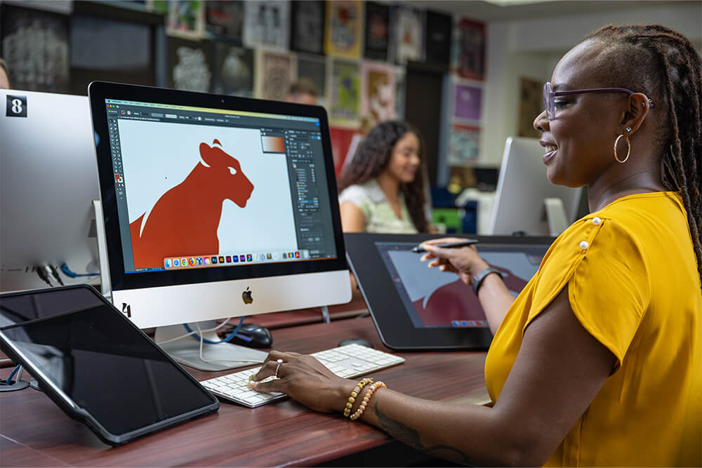 Graphic Design student in design lab at the computer