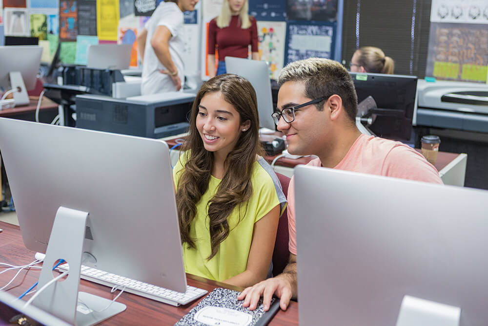 Graphic Design students in design lab at the computer