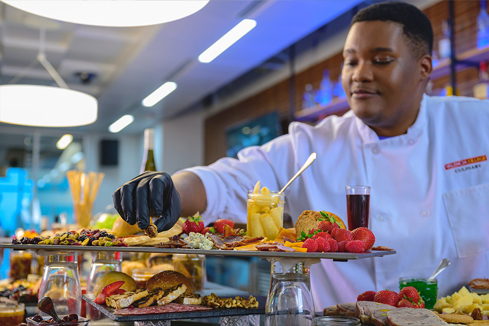 Male student preparing banquet charcuterie