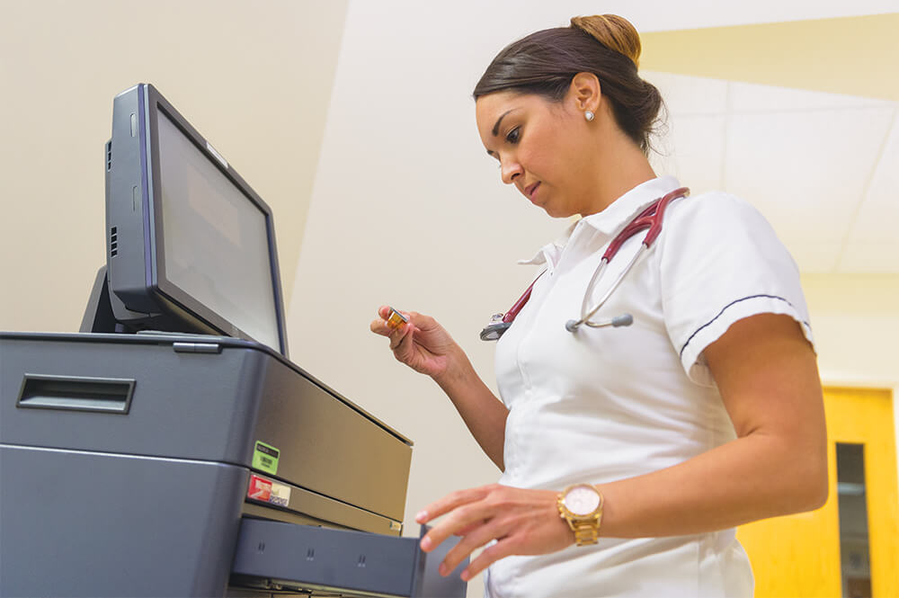 Female nurse entering data into computer