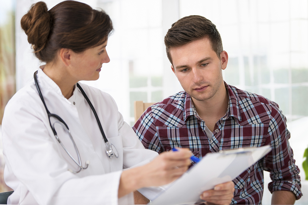Female doctor with patient reviewing chart